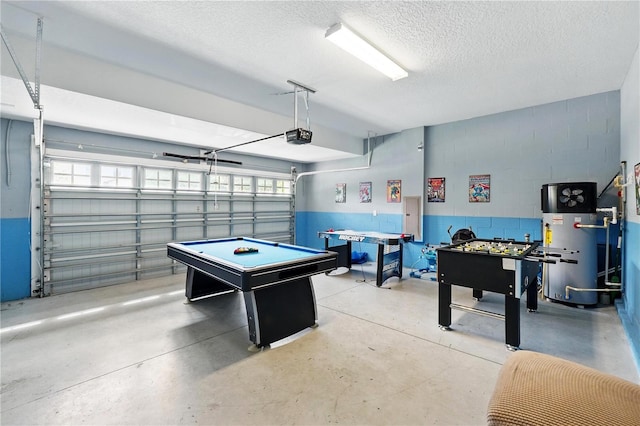1432 Rolling Fairway Dr, Davenport, FL 33896 - rec room with a textured ceiling, gas water heater, a garage, finished concrete floors, and concrete block wall