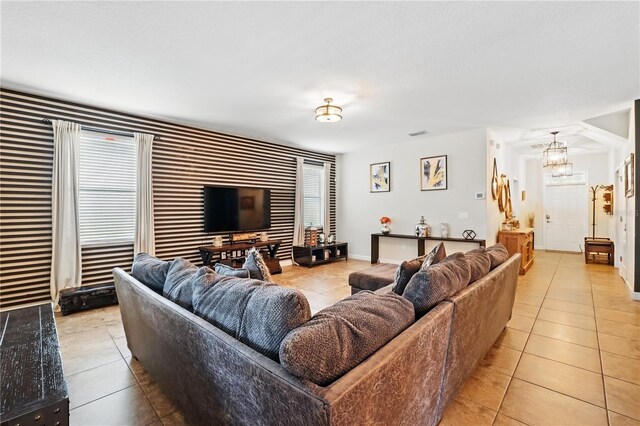 1432 Rolling Fairway Dr, Davenport, FL 33896 - living room featuring visible vents, a notable chandelier, light tile patterned flooring, and baseboards