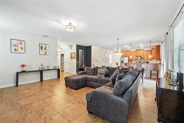 1432 Rolling Fairway Dr, Davenport, FL 33896 - living room featuring light tile patterned floors, baseboards, and visible vents
