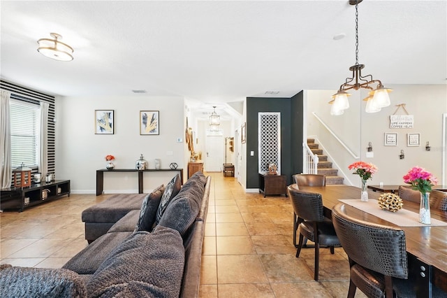1432 Rolling Fairway Dr, Davenport, FL 33896 - living area featuring stairway, visible vents, an inviting chandelier, and light tile patterned flooring