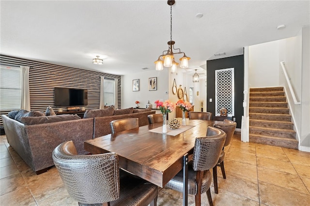 1432 Rolling Fairway Dr, Davenport, FL 33896 - dining room with stairway, a notable chandelier, baseboards, and light tile patterned flooring