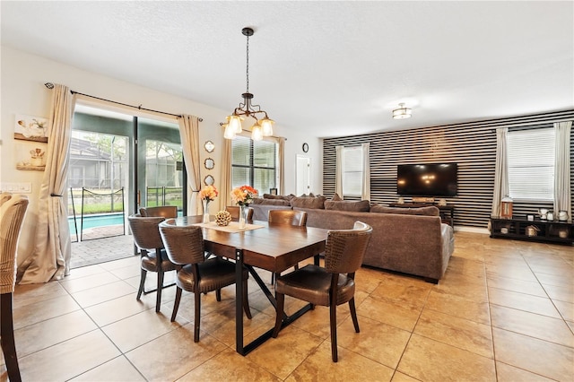 1432 Rolling Fairway Dr, Davenport, FL 33896 - dining space featuring light tile patterned floors, a notable chandelier, and a textured ceiling