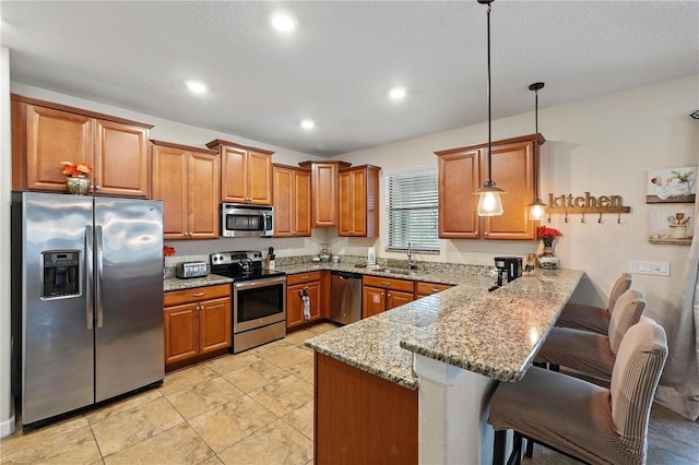 1432 Rolling Fairway Dr, Davenport, FL 33896 - kitchen featuring a sink, a breakfast bar, a peninsula, brown cabinetry, and stainless steel appliances