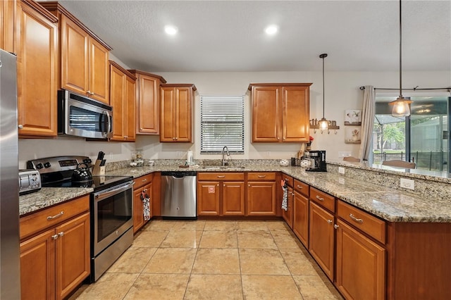 1432 Rolling Fairway Dr, Davenport, FL 33896 - kitchen with brown cabinetry, a peninsula, and appliances with stainless steel finishes