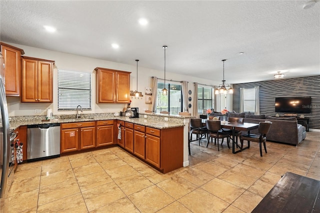 1432 Rolling Fairway Dr, Davenport, FL 33896 - kitchen with brown cabinets, open floor plan, a peninsula, and dishwasher