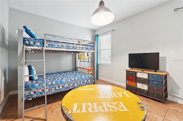 1432 Rolling Fairway Dr, Davenport, FL 33896 - bedroom with baseboards, light tile patterned flooring, and a textured ceiling
