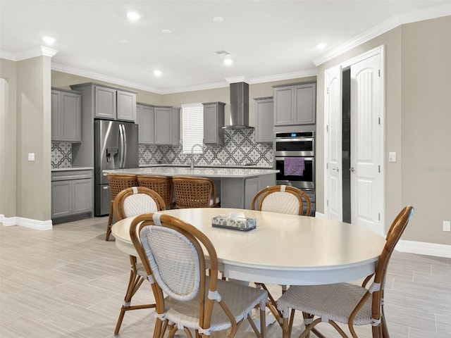 dining space with baseboards and ornamental molding
