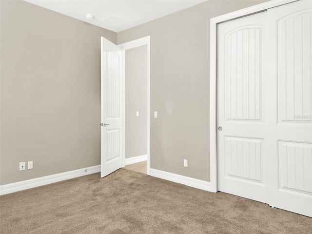 unfurnished bedroom featuring baseboards, a closet, and carpet floors