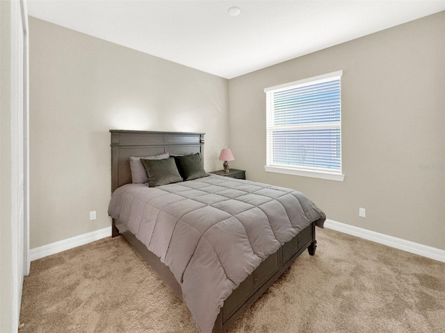 bedroom with carpet and baseboards