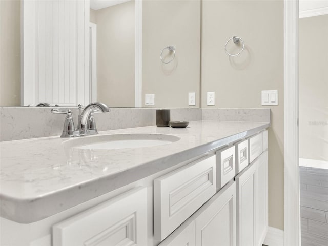 bathroom with baseboards and vanity
