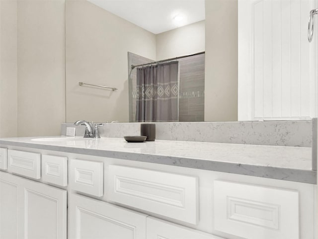 bathroom featuring vanity and curtained shower