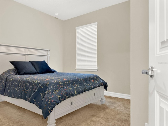bedroom with carpet flooring and baseboards