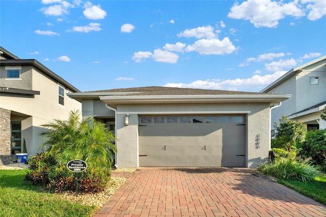 garage with decorative driveway