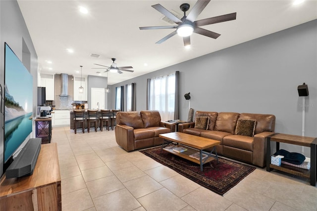 living room with light tile patterned floors, recessed lighting, and a ceiling fan