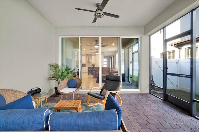 sunroom featuring plenty of natural light and ceiling fan