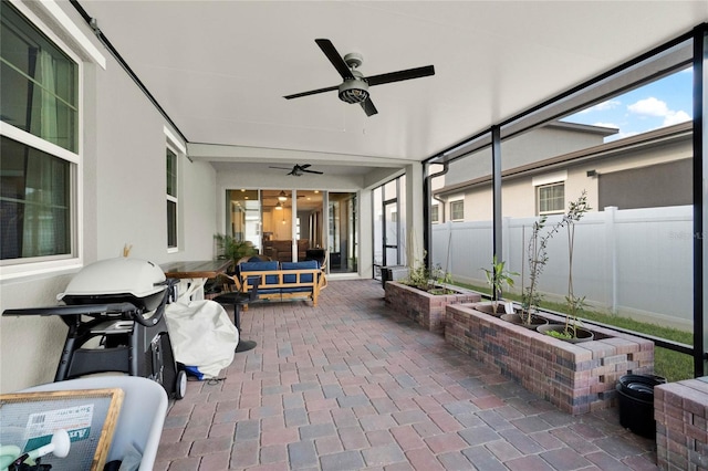 view of patio featuring a grill, fence, and ceiling fan