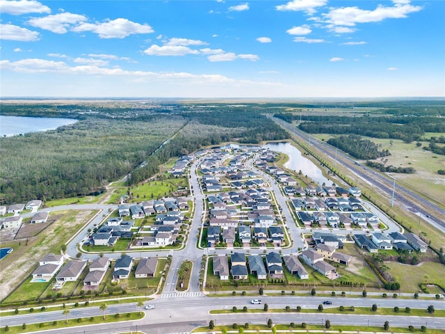 drone / aerial view featuring a residential view and a water view