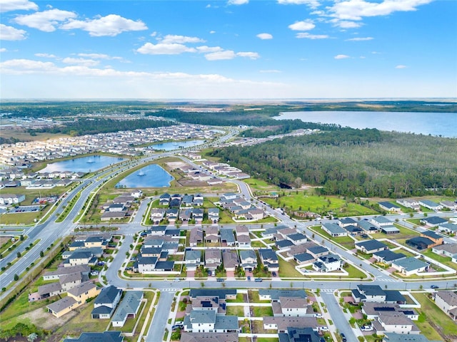 drone / aerial view featuring a residential view and a water view