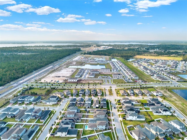 birds eye view of property featuring a residential view and a water view