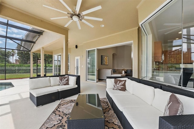 view of patio featuring glass enclosure, fence, an outdoor living space, and a ceiling fan