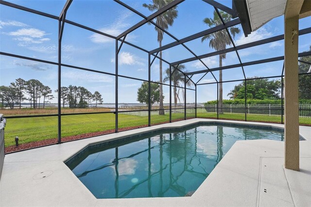 pool featuring a lanai, a yard, and a patio area
