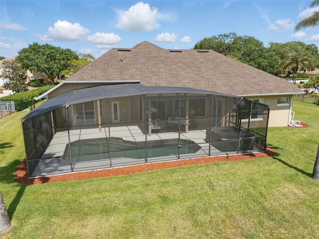 rear view of property featuring a lawn, glass enclosure, a patio area, and an outdoor pool