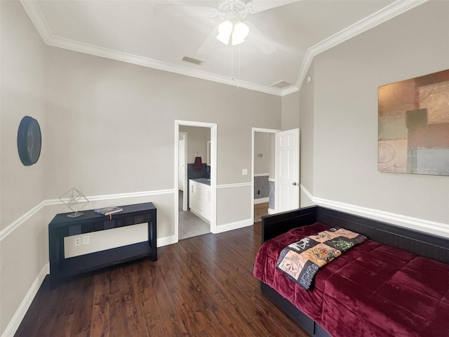 bedroom with wood finished floors, crown molding, baseboards, ensuite bath, and a ceiling fan