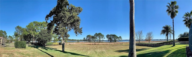 view of community featuring a lawn and a water view
