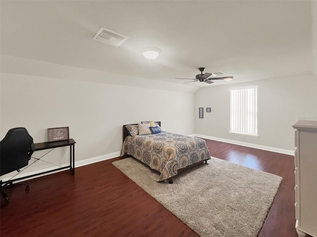 bedroom featuring dark wood-style floors, baseboards, ceiling fan, and an office area