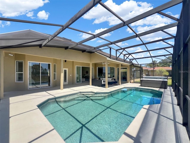 swimming pool featuring a hot tub, a patio area, an outdoor hangout area, ceiling fan, and a lanai