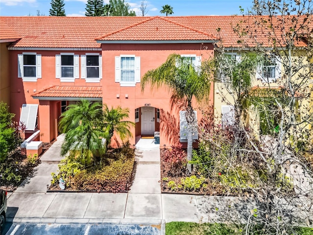 view of front of house featuring stucco siding and a tile roof