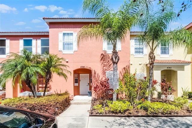 mediterranean / spanish-style home with stucco siding and a tiled roof