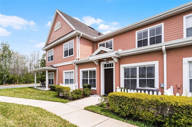 view of front of property with a front lawn and stucco siding