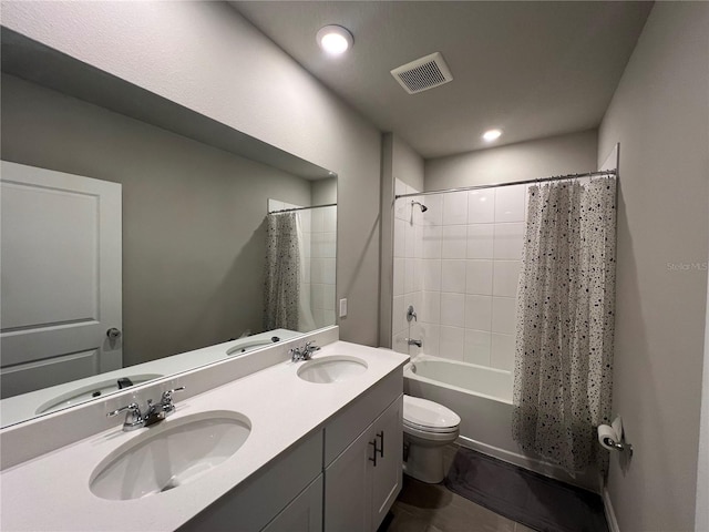 full bathroom featuring shower / tub combo, toilet, visible vents, and a sink