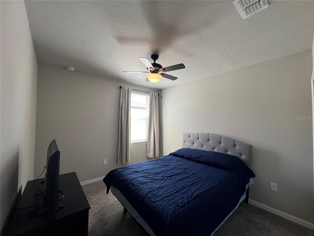 bedroom with visible vents, a ceiling fan, a textured ceiling, carpet, and baseboards