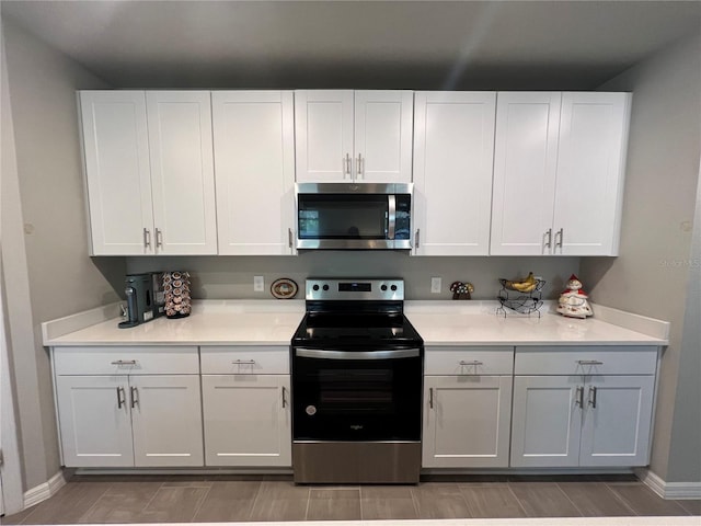 kitchen featuring white cabinetry, light countertops, and stainless steel appliances