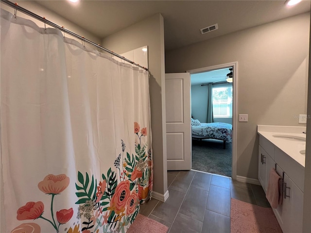 full bath with visible vents, connected bathroom, baseboards, tile patterned floors, and vanity