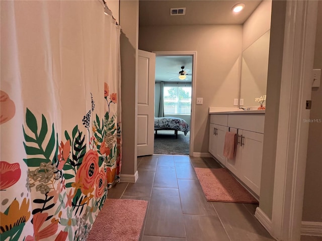 ensuite bathroom featuring visible vents, connected bathroom, baseboards, tile patterned floors, and vanity