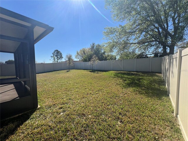 view of yard with a fenced backyard