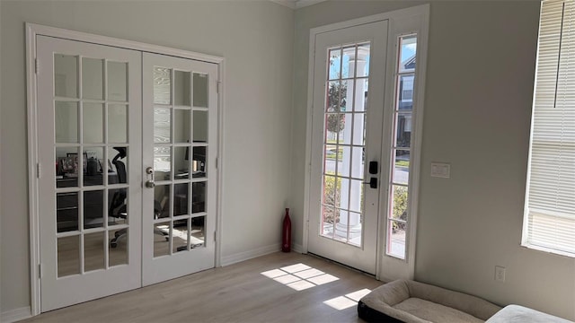 10197 Ridgebloom Ave, Orlando, FL 32829 - doorway with french doors, baseboards, and wood finished floors