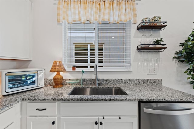 1153 Augustus Dr, Davenport, FL 33896 - kitchen featuring a sink, white cabinetry, light stone countertops, stainless steel dishwasher, and a toaster