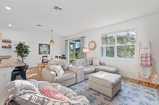 1153 Augustus Dr, Davenport, FL 33896 - living area featuring light wood finished floors, baseboards, visible vents, and recessed lighting