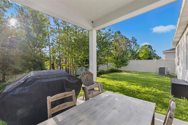 1153 Augustus Dr, Davenport, FL 33896 - view of patio with area for grilling, a fenced backyard, and central AC unit