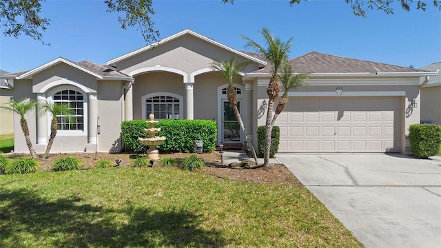 ranch-style house featuring stucco siding, an attached garage, a front lawn, and driveway