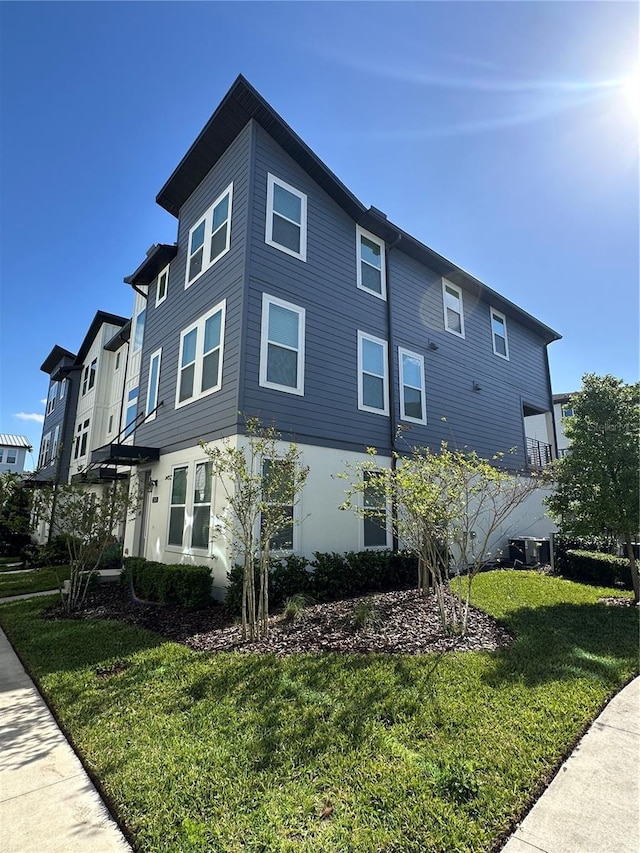 12673 Yoshino Aly, Orlando, FL 32827 - view of property exterior featuring a lawn and stucco siding