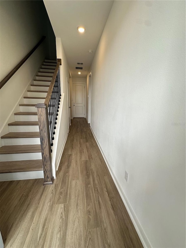 12673 Yoshino Aly, Orlando, FL 32827 - hallway with visible vents, wood finished floors, recessed lighting, stairway, and baseboards