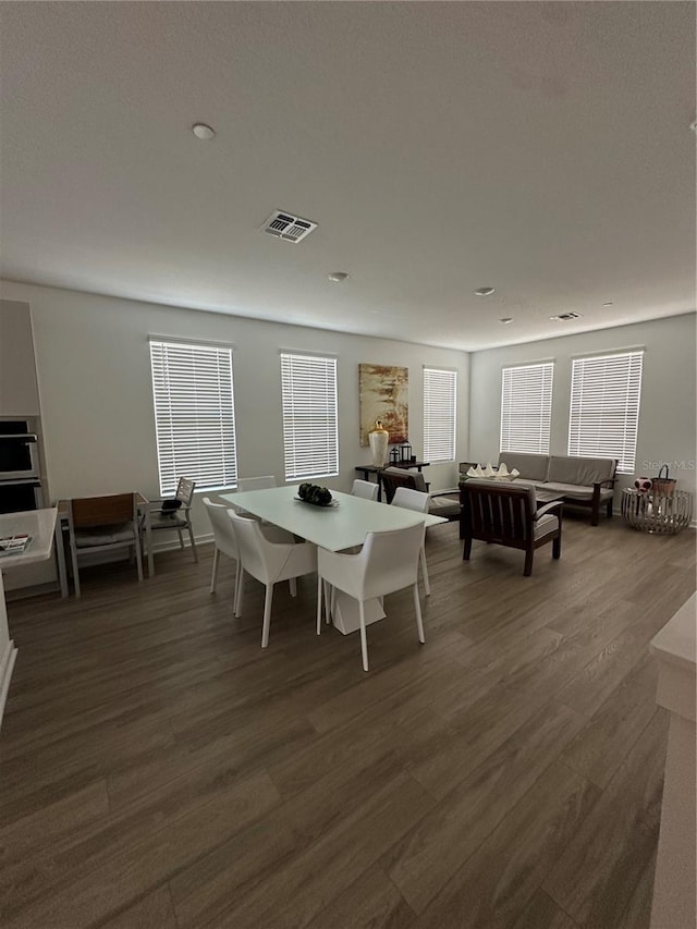 12673 Yoshino Aly, Orlando, FL 32827 - dining area with dark wood-style floors and visible vents