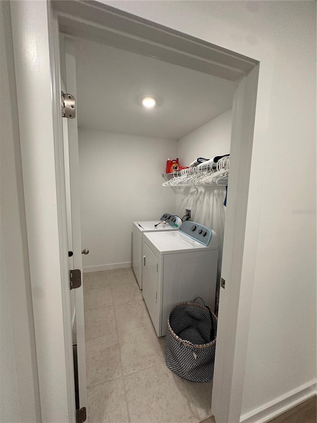 12673 Yoshino Aly, Orlando, FL 32827 - clothes washing area with laundry area, light tile patterned floors, baseboards, and independent washer and dryer