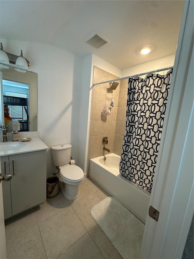 12673 Yoshino Aly, Orlando, FL 32827 - full bathroom featuring vanity, visible vents, shower / tub combo, tile patterned floors, and toilet