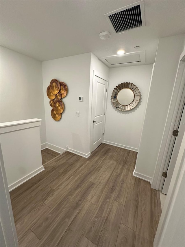 12673 Yoshino Aly, Orlando, FL 32827 - corridor featuring visible vents, baseboards, attic access, and wood finished floors